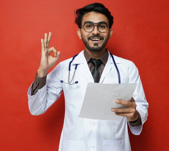 a man in a white coat holding a piece of paper
